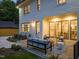 Outdoor patio with seating, landscape lighting, and verdant lawn, ideal for evening relaxation at 909 N Gregson St, Durham, NC 27701