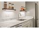 Wet bar with undermount lighting, marble counters, and stainless dishwasher and beverage center at 909 N Gregson St, Durham, NC 27701