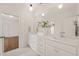 Bright white bathroom with dual sinks, a marble countertop, and hardwood floors at 909 N Gregson St, Durham, NC 27701