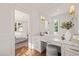 Bright white vanity area with marble countertop, drawers, mirror and padded stool at 909 N Gregson St, Durham, NC 27701