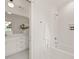 Bright white bathroom with tile floor, subway tile, shower and integrated shampoo nook at 909 N Gregson St, Durham, NC 27701