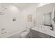 Bright bathroom featuring subway tile, a soaking tub and shower combo, plus stylish fixtures at 909 N Gregson St, Durham, NC 27701