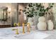 Close-up of a bathroom with a marble countertop and gold fixtures at 909 N Gregson St, Durham, NC 27701