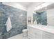 Bathroom with blue subway tile, a white vanity, and modern fixtures at 909 N Gregson St, Durham, NC 27701