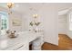 Bright white vanity area with marble countertop, drawers, mirror and padded stool at 909 N Gregson St, Durham, NC 27701