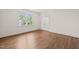A bright bedroom features wood floors, double door closet, and a window providing natural light at 909 N Gregson St, Durham, NC 27701