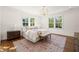 Bright bedroom with large windows, hardwood floors, and a stylish chandelier at 909 N Gregson St, Durham, NC 27701