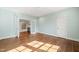Bedroom with hardwood floors and blue walls with doors leading to bonus room at 909 N Gregson St, Durham, NC 27701