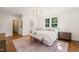 Well-lit bedroom with white walls, hardwood flooring, and modern furnishings at 909 N Gregson St, Durham, NC 27701