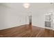 Empty bedroom with hardwood floors, white walls and entry to a nearby bathroom at 909 N Gregson St, Durham, NC 27701