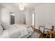 Bedroom with a chair, white walls and a view into the bathroom at 909 N Gregson St, Durham, NC 27701