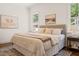 Bright bedroom with a neutral palette, plush bedding, and natural light at 909 N Gregson St, Durham, NC 27701