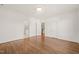 Empty bedroom with hardwood floors, white walls and entry to a nearby bathroom at 909 N Gregson St, Durham, NC 27701
