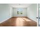 Bedroom with hardwood floors, blue walls and large window for natural light at 909 N Gregson St, Durham, NC 27701