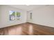 Empty bedroom with hardwood floors, white walls, large windows and elegant trim at 909 N Gregson St, Durham, NC 27701