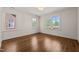 Empty bedroom with hardwood floors, white walls, large windows and elegant trim at 909 N Gregson St, Durham, NC 27701