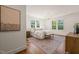 Bedroom with large windows, hardwood floors, and warm accents at 909 N Gregson St, Durham, NC 27701