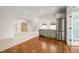 Bonus room with bar area, wood flooring, and access to attic storage space at 909 N Gregson St, Durham, NC 27701