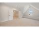 Neutral bonus room with carpet, built in window bench, and door to finished attic space at 909 N Gregson St, Durham, NC 27701