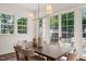 Bright dining area boasts natural light, complemented by a stylish chandelier and views of the backyard at 909 N Gregson St, Durham, NC 27701
