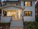 Charming front porch with stone flooring, white brick pillars, and an inviting entrance with a glass-paneled front door at 909 N Gregson St, Durham, NC 27701