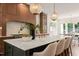 Kitchen island with counter seating, pendant lighting, and modern cabinetry at 909 N Gregson St, Durham, NC 27701