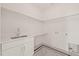 A laundry room featuring white cabinets, a stainless steel sink, and patterned floors at 909 N Gregson St, Durham, NC 27701