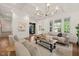 Spacious living room with hardwood floors, coffered ceilings, large windows, and a cozy seating arrangement at 909 N Gregson St, Durham, NC 27701