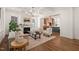 Open-concept living room featuring a fireplace, hardwood floors, and a view into the kitchen area at 909 N Gregson St, Durham, NC 27701