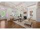 Elegant living room with coffered ceilings, a marble fireplace, hardwood floors, and a cozy seating arrangement at 909 N Gregson St, Durham, NC 27701
