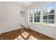 Bright room with hardwood flooring, white trim, and large windows at 909 N Gregson St, Durham, NC 27701