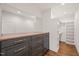 Walk-in closet with dark gray drawers, hanging rods, inset lighting and hardwood floors at 909 N Gregson St, Durham, NC 27701