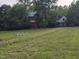 Exterior view of spacious lawn leading to two-story home at 915 Phils Creek Rd, Chapel Hill, NC 27516