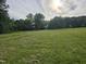 Backyard view of manicured lawn leading up to a home at 915 Phils Creek Rd, Chapel Hill, NC 27516