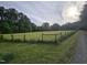 View of a large green backyard with a house in the distance at 915 Phils Creek Rd, Chapel Hill, NC 27516