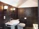 The stylish bathroom features dark stone tiled walls, modern fixtures, and a white sink and toilet at 915 Phils Creek Rd, Chapel Hill, NC 27516