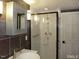 Bathroom features gray marble walls, glass shower, modern sink, and vanity at 915 Phils Creek Rd, Chapel Hill, NC 27516