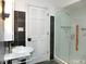 Bathroom features marble walls, glass shower, modern sink, and white door at 915 Phils Creek Rd, Chapel Hill, NC 27516