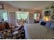 Comfortable bedroom featuring large bed, sitting area, and outdoor views through french doors at 915 Phils Creek Rd, Chapel Hill, NC 27516