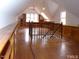 Spacious bonus room with hardwood floors, built in shelving and lots of natural light from the many windows at 915 Phils Creek Rd, Chapel Hill, NC 27516