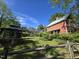 Beautiful home and backyard featuring a gazebo, lush green grass, a decorative fence and lots of plants at 915 Phils Creek Rd, Chapel Hill, NC 27516