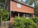 Inviting two-story home featuring a cozy covered porch, rustic wood accents, and lush greenery at 915 Phils Creek Rd, Chapel Hill, NC 27516