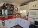 Bright kitchen features a red countertop, white cabinets, hanging pot rack and black accents at 915 Phils Creek Rd, Chapel Hill, NC 27516