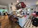Unique kitchen island, stylish black and white floors, hanging pots and views to the dining area at 915 Phils Creek Rd, Chapel Hill, NC 27516