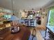 Spacious kitchen with stylish countertops, hanging pot rack, and access to dining area at 915 Phils Creek Rd, Chapel Hill, NC 27516