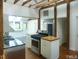Bright kitchen features stainless steel appliances, light cabinets, and wooden support beams at 915 Phils Creek Rd, Chapel Hill, NC 27516