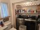 Functional laundry room with modern washer and dryer, storage shelves, and ample space at 915 Phils Creek Rd, Chapel Hill, NC 27516