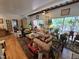 Bright living room with hardwood floors, beamed ceiling, large windows, and lots of plants at 915 Phils Creek Rd, Chapel Hill, NC 27516