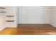 Bright living room with wood floors, white walls, and dark wooden shelves at 915 Phils Creek Rd, Chapel Hill, NC 27516
