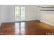 Bright living room with wood floors, white walls, and French doors to a balcony at 915 Phils Creek Rd, Chapel Hill, NC 27516